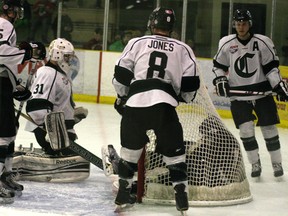 Members of the Sherwood Park Flyers, including goalie Matt Tomkins, spent some time digging Spruce Grove Saints out of their net as well as pucks fired into their net by the Saints, during the Groveís impressive 4-1 win that clinched their fifth consecutive AJHL North division title last weekend. Photo by Gord Montgomery.