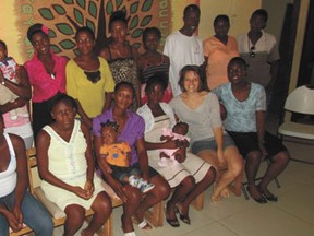 Sarah Wallace (front row, second from right) with Olive Tree Projects staff members and some of the mothers and children they serve