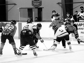 The Paisley Old Guys #2 (over 50) (in black) and the Paisley Rebels (in white) lining up for a face-off during one of the hockey games of the OldTimer's Hockey Tournament on the Feb. 22 weekend.