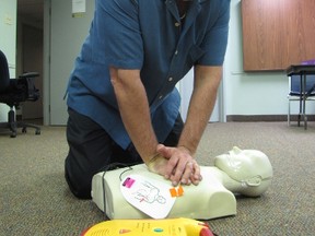 Jim Russell, a first aid and CPR instructor, demonstrates life-saving techniques during a break in a class Wednesday at the Canadian Red Cross office in Sarnia. The local branch of the Red Cross is offering training specials during March. Sarnia, Ont., Feb. 27, 2013  PAUL MORDEN/THE OBSERVER/QMI AGENCY