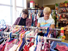 Audrey Antworth, left, and Barb Ramsden sort children's clothing on March 1, 2013 for today's big sale at the St. Vincent De Paul Thrift Shop on King Street East in downtown Chatham, On. The agency is celebrating 50 years by offering 1963 prices for clothing and footwear.  (BOB BOUGHNER, The Chatham Daily News)