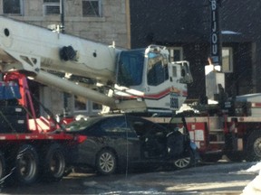 A sedan is wedged between a crane and its trailer at the intersection of Main and Second St. S. shortly after 4 p.m. Friday.
Shirley Mack for the Miner and News