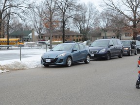 A Cathcart Public student crosses Marianna Place, just west of the school, on Thursday. Drivers have been known to double park on the street. They've been spotted blocking a gate where students enter and exit the school property. (BLAIR TATE, Special to The Observer)