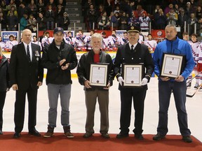 Former NHL player Brett MacLean claps after St. John Ambulance Life Saving Awards were presented to Eldon Silverthorn, who accepted on behalf of his son Jason Silverthorn, Jay Forslund and Jason Gallagher prior to the Kitchener Rangers and Owen Sound Attack OHL match up Friday, March 01, 2013 at the Lumley Bayshore in Owen Sound. The men helped save MacLean's life after he collapsed while playing pick up hockey at the Owen Sound Recreation Centre on July 2nd, 2012. Presenting the awards were St. John Ambulance Grey-Bruce-Huron Branch Manager Kathy Murphy Ermel, left, and St. John Ambulance Grey Bruce Huron Board Chair Drew Wilder, 2nd from left. --JAMES MASTERS/QMI Agency/The Sun TimesDignitaries and fans applaud following the presentation of distinguished St. John Ambulance Life Saving Awards to (R-L) Jason Gallagher, Eldon Silverthorn accepting on behalf of his son Jason Silverthorn and Jay Forslund, prior to the Kitchener Rangers Owen Sound Attack OHL match up Friday, March 01, 2013 at the Lumley Bayshore in Owen Sound. The three men were recognized for taking life saving action when Brett MacLean, 4th from the left, collapsed on the ice during a pick up game of hockey at the Owen Sound Recreation Centre on July 2nd, 2012.-