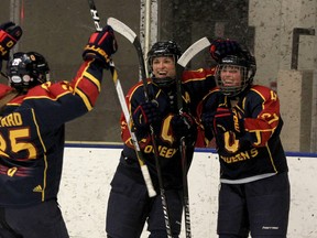 Queen's Golden Gaels, from left, Danielle Girard, Morgan McHaffie and  Brittany McHaffie celebrate Brittany's power play goal against the Western Mustangs during Game 2 Ontario University Association final action at the Kingston Memorial Centre on Friday night.