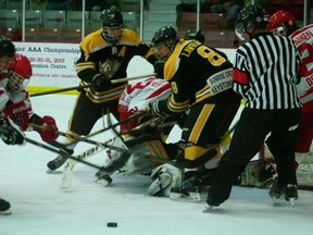 Kenora Midget Thistles' Mikko Keski-Pukkila gets thrown to the ice by two Brandon Wheat Kings after trying to find the rebound in front of the net. The Thistles lost the game 4-3 and subsequently lost the series 3-0. 

GRACE PROTOPAPAS/KENORA DAILY MINER AND NEWS