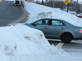 The sightline from Van Horne Street turning onto the Bridge of Nations is blocked due to the high snow banks.
Inset: Potholes have been forming faster than city crews can repair them due to fluctuations in temperature. (GINO DONATO/Sudbury Star)