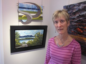 Debbie Richards with pieces in the Gallery in the Grove art show Double Vision that features work by Richards and her twin sister Diane Stewart. The show opens Sunday and runs through March 23. (PAUL MORDEN, The Observer)