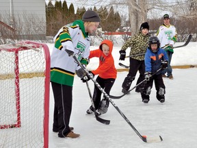 Brent Wold, left, and Riley Hay, right, of the Portage Terriers took on some of the kids from the Peony Farm neighbourhood in a continuous game of shinny hockey Saturday at Shiver Day. Pictured are Kenny Sheppard, Joel Simpson and Atli Grimolfson. (CLARISE KLASSEN/PORTAGE DAILY GRAPHIC/QMI AGENCY)