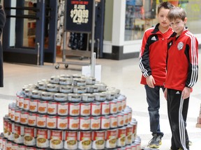 Tristen Konrad and Dean Palimaka, both 10-year-olds with the Sarnia Football Club, check out part of the team's CANstruction display Saturday at the Lambton Mall. The 'Soccer's Paradise' sculpture, made out of cans and other non-perishable food items, was one of 18 entered in this year's CANstruction Sarnia-Lambton food drive for the Inn of the Good Shepherd. TYLER KULA/ THE OBSERVER/ QMI AGENCY