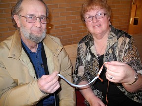 Dan Paterson and Joan Barnes tie two ribbons together to signify a welcoming gesture during the World Day of Prayer service at Delhi United Church on Friday, March 1, 2013. SARAH DOKTOR Simcoe Reformer/QMI Agency.
