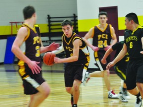 Michael Lavallee of the PCI Trojans varsity basketball team dribbles during a game against Tec Voc earlier this season. (Kevin Hirschfield/PORTAGE DAILY GRAPHIC/QMI AGENCY)