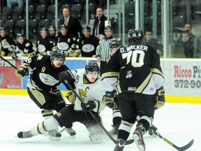 Cobourg Cougars captain Evan Jasper is surrounded by Trenton Golden Hawks Nick Marinac, Truman Landowski and Dillan Walker during the Cougars' 2-0 win Saturday at the Cobourg Community Centre.