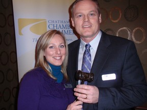 Sarah Callow of Chatham, On. presents Chris Appleton, newly-elected chair of the Chatham-Kent Chamber of Commerce, with a gavel following the organization's annual general meeting.