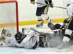 Cobourg Cougars' Colbie Andrews slams into Trenton Golden Hawks' goalie Andrew Winsor resulting in a controversial goal during the Cougars' 5-4 win Sunday at the Community Gardens.