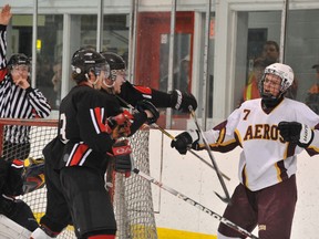 Athens Aeros forward Shane Hiley (7) tangles with Gananoque Islanders Lucas Stitt (3) and Jonathon Smith in front of the Gananoque net in third-period action at Centre 76 Sunday night. RONALD ZAJAC The Recorder and Times