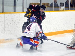 Andrew Van Vliet (44) of the Monkton Wildcats battles for the puck behind the Komoka net with Classics’ goalie K.J. Robinson last Friday during Game 2 of their WOAA ‘AA’ South semi-final series last season.
ANDY BADER/QMI AGENCY