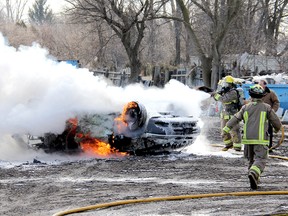 Firefighters from Chatham South Station No. 7 quickly doused this vehicle that caught fire at Ritchie Recycling on McNaughton Line, just east of Chatham, shortly after 11 on Monday. ELLWOOD SHREVE/ THE CHATHAM DAILY NEWS/ QMI AGENCY