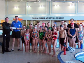 Dave Omichinski of Portage Credit Union presents a cheque for $1,500 to Hans Stasiuk, Rob Pehura, and the swimmers of the Central Plains Aquatic Club, Friday, at the Shindleman Aquatic Centre. The funds will be used to purchase an iPad, a laptop, and computer software to assist swimmers in  training and registering for swim meets. (ROBIN DUDGEON/PORTAGE DAILY GRAPHIC/QMI AGENCY)