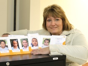 Susan Hodges shows pictures of some of the children she will get to meet when she travels to Nicaragua next month.