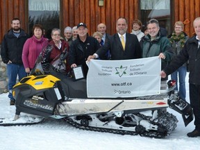 Members of the Mattagami Ski Club in Smooth Rock Falls gathered at the facility Sunday to celebrate the news that Ontario Trillium Foundation has providing $14,000 to purchase a snowmobile to replace one of the ones that were stolen. Among those who attended the celebration were, front row from left, directors Jocelyne Isaacson, Sue Boivin, club president Rick Isaacson, MPP Gilles Bisson (NDP – Timmins-James Bay), club co-founder Wayne McGee and  Mayor Mitch Arseneault.