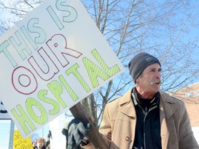 TRENTON, ON (03/04/2013) Brighton resident Paul Young holds a sign as he joins in the approximately 100 people outside Trenton Memorial Hospital on Monday, March 4, 2013. Members of the public were protesting proposed cuts and reductions in services at Trenton Memorial Hospital. The rally was organized by the Ontario Health Coalition. 
EMILY MOUNTNEY/TRENTONIAN/QMI AGENCY