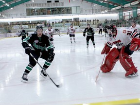 Thunder forward Frederic Tanguay brings the puck into the Wolverines end while Wolverines netminder Tanner Kovacs keeps a close watch during second period action at the Omniplex on Mar. 1.