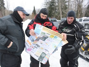 William King, left, Leon Hyman and Dan George, snowmobilers from North Java, N.Y., work out their route Saturday, March 2, 2013, at The Portage in North Bay. The three men have been snowmobiling in the area for the last 10 to 15 years and say conditions in the area this year are "great."