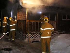 Members of the Melfort Fire Department attack a fire in a home at 509 Crawford Ave West on Monday, March 4.