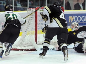 Trenton Golden Hawks' Victor Adamo reaches back in vain for Cody Mintz's knuckle puck that completes a four-game sweep for the Cobourg Cougars Monday night at the Cobourg Community Centre.