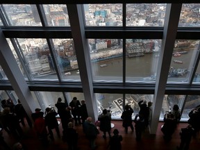 Visitors look out from windows in The View gallery at London's new Shard, western Europe's tallest building. REUTERS/Andrew Winning