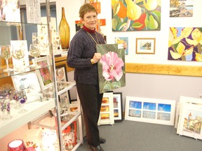 Local artist Sandra Florence poses amidst some of her vibrant offerings in Kincardine's Victoria Park Gallery. Florence's work will be featured as part of the Saugeen Room Showcase at Cava Coffee Cafe through April 8.