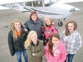 Local female aviators including, front row from left, Meggan Kittmer, 16, and Angelica Price, who plans to solo when she turns 14 in April, and back row, from left, Kayla Veldman, 17, Lisa Wesson, 48, Patti Ladd, 53, and Emma Redfearn, 15, are among the many celebrating Women of Aviation Worldwide Week. (SCOTT WISHART, The Beacon Herald)
