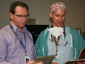 Rob Croft, chief information office for Grey Bruce Health Services, and Dr. Travis Nairn use their tablets outside the operating room Tuesday March 5 at the Owen Sound hospital.