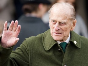 Prince Philip, Duke of Edinburgh waves to well-wishers as he leaves following the Royal family Christmas Day church service at St Mary Magdalene Church in Sandringham, Norfolk, in the east of England, on December 25, 2012. (AFP PHOTO/LEON NEAL)