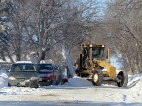 A plow clears snow on 13th St. NW near Fort la Reine School. The City has been busy clearing streets since a large storm dropped on Portage la Prairie, Monday. It is expected that the work will be completed by Thursday. (ROBIN DUDGEON/PORTAGE DAILY GRAPHIC/QMI AGENCY)