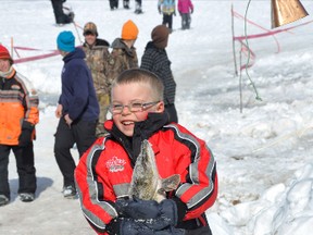 Top angler of the Ernie Eddy Children’s Ice Fishing Derby, Jaze St. Pierre, 5, of Sault Ste. Marie, carries his five-pound, six-ounce pike.