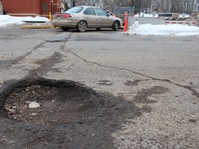 Parking lots are not immune to potholes either.  JORDAN THOMPSON/QMI Agency