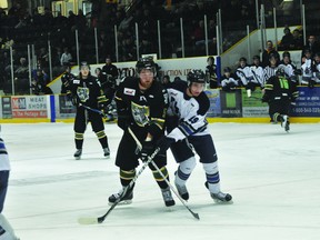 Terriers defenceman Dylan Kuczek and Pistons forward Nicholas Kobelka battle during a game in Portage earlier this year. (Kevin Hirschfield/PORTAGE DAILY GRAPHIC/QMI AGENCY)