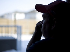 "Peter" looks out his window in the Hollick-Kenyon neighbourhood in Edmonton, Alta., on Tuesday, March 5, 2013. The man lives near a legal marijuana grow-op in the neighbourhood, which he feels has negatively affected the area. His identity has been hidden for protection. Ian Kucerak/Edmonton Sun/QMI Agency