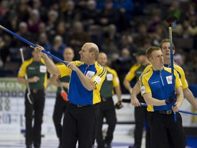 Alberta skip Kevin Martin, left, and second Marc Kennedy salute the crowd following the sixth draw of the Tim Hortons Brier at Rexall Place in Edmonton on Monday. The success of the Scotties Tournament of Hearts in Kingston in February could translate into a Brier for the city at some point in the future. (Ian Kucerak/QMI Agency)