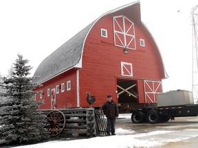 Grain farmer Dave Schmidt stands beside his barn at his acreage south of LaGlace on Highway 724 Tuesday. Today the barn is being hauled a few miles up the road to his daughter Bernice’s property. The 1,500 square foot barn was built in 1936 and has been a part of the Schmidt family for decades. (Patrick Callan/Daily Herald-Tribune)
