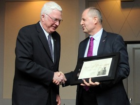 GPRC Board of Governors chairman Vince Vavrek (right) hands Fletcher Bootle the GPRC Board of Governors Award of Distinction during the 2013 President’s Awards Luncheon held in the Pomeroy Hotel, Tuesday. (Aaron Hinks/Daily Herald-Tribune)