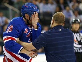 Marc Staal of the New York Rangers is helped off the ice after he was hit in the face with a puck in the third period against the Philadelphia Flyers Tuesday night. (AFP)