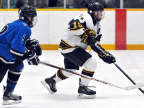 CKSS Golden Hawks' Tristen Allen, right, is chased by Villanova Wildcats' Brodin Meloche during the SWOSSAA 'AAA-AAAA' boys hockey final Tuesday at Erickson Arena. (DIANA MARTIN/The Daily News)