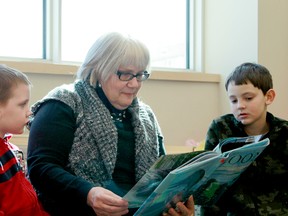 Connor, left, and Jaimen, right, listen to a story being ready by Children's Librarian Rosemary Kirby.

Nigel Stewart for the Trentonian