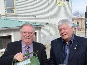 Wray Lamont, left, and Dan Kerr, both former South Bruce Peninsula councillors, show off a household green bin for organic waste and some of the types of recyclables that they believe are being thrown into the garbage.