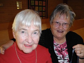 Eva Vickery and Joan Helmer tie two ribbons together to signify a welcoming gesture during the World Day of Prayer service at Delhi United Church on Friday. (SARAH DOKTOR Delhi News-Record)