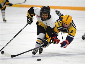 Plattsville novice Warren Leeder (right) tries to intercept Langton Lions' Josh King during Game 1 of their OMHA DD novice semifinal. Plattsville went on to win the best-of-five series in three games. CHRIS ABBOTT/TILLSONBURG NEWS