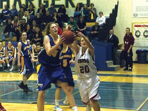 Bert Church Charger Hayley Sera, left, brings down a rebound in front of Cochrane Cobras Marina Janzen during Cochrane’s 47-37 victory in the Rocky View senior girls’ basketball division championship game on Saturday evening at the Bert Church gym.

CHRIS SIMNETT/AIRDRIE ECHO